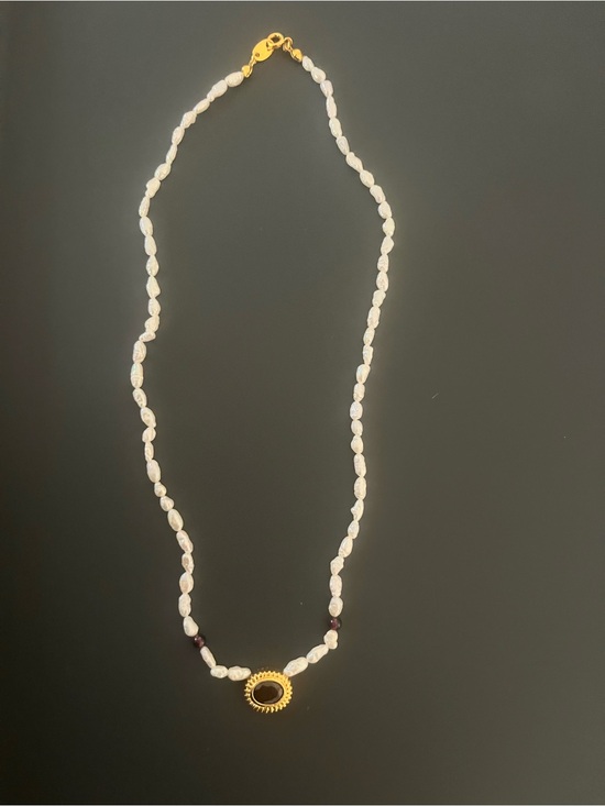 it’s stamped but I’m unable to read it Jewelry - Pearl Necklace with Gold Ring and Garnet Accent Beads